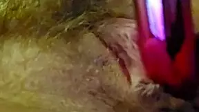 woman moans softly while rubbing clit with vibrator and fingers gently