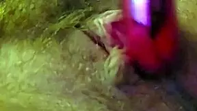 woman moans softly while rubbing clit with vibrator and fingers gently