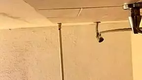 a cute girl sprinkles water playfully in her steamy shower scene