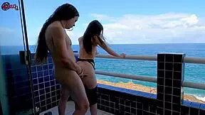 Having so much fun on the terrace balcony rooftop in front of ocean kissing flashing big natural tits pretty brunette babe