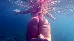 pawg slips into thong bikini for underwater swim shots