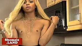 young ebony shemale grabs her cock for a teasing solo rub in the kitchen
