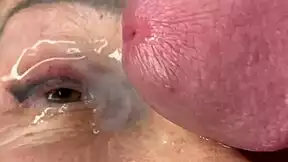 mature lady takes huge facial jizz load right on her eyes closeup