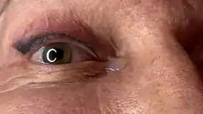 mature lady takes huge facial jizz load right on her eyes closeup