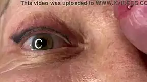 mature lady takes huge facial jizz load right on her eyes closeup