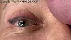 mature lady takes huge facial jizz load right on her eyes closeup