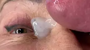 mature lady takes huge facial jizz load right on her eyes closeup