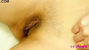 sexy asian teen strips naked for close-up tease on the sofa