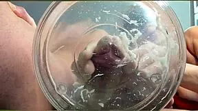 A gilf receives slow-motion cumshot in water from her muscular friend