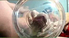 A gilf receives slow-motion cumshot in water from her muscular friend