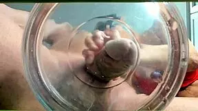 A gilf receives slow-motion cumshot in water from her muscular friend