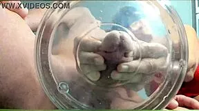 A gilf receives slow-motion cumshot in water from her muscular friend