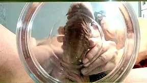 A gilf receives slow-motion cumshot in water from her muscular friend