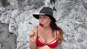 A stepmom sucks candy on beach then slurps stepson's cock hungrily