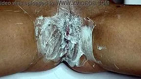 Watch this closeup of shaving a wet pussy smooth with trimmer and razor in the bathroom