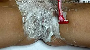 Watch this closeup of shaving a wet pussy smooth with trimmer and razor in the bathroom