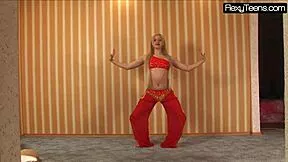 Sexy Russian belly dancer stretches flexible body teasing in red gym dress