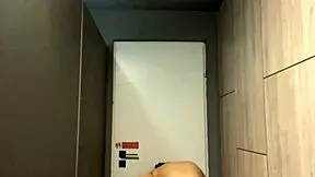 A young woman pleasures herself alone in the gym during a quiet moment after workout, seeking private release.