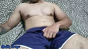 young guy in shorts strokes his huge hard cock until massive ejaculation