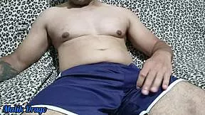 young guy in shorts strokes his huge hard cock until massive ejaculation