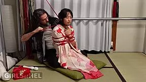 Rope-suspended Asian babe endures pussy clamps in tight kinky domination session