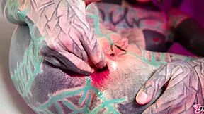 Tattooed goth beauty fingers her gaping asshole deep in wild solo anal fisting masturbation.