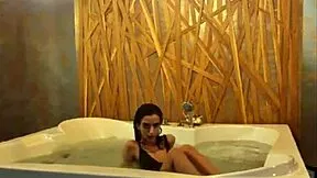 brunette playfully teases and dances around in the jacuzzi