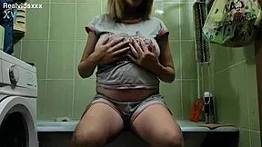 A very pregnant 19-year-old masturbates her shaved pussy in bathroom