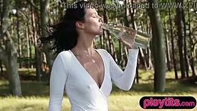 petite german milf slowly strips naked amid forest trees bombshell body