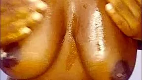 ebony slut oils up huge tits and begs for your hot jizz close-up?