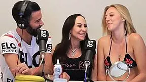 blonde and brunette share banana topped with cream in playful licking scene