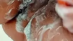 this young latina brunette shaves her hairy pussy close up in the bathroom