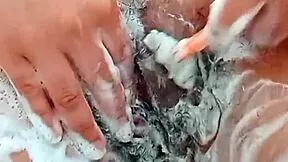 this young latina brunette shaves her hairy pussy close up in the bathroom