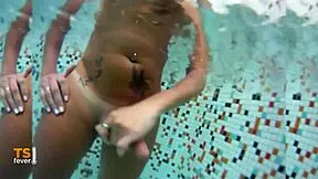 underwater shemale strokes her monster cock in the pool