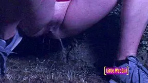 Pissing outdoors in a meadow at night