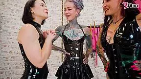 Three latex goddesses destroy the tattooed slave with urethral fingering