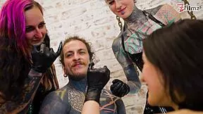 Three latex goddesses destroy the tattooed slave with urethral fingering